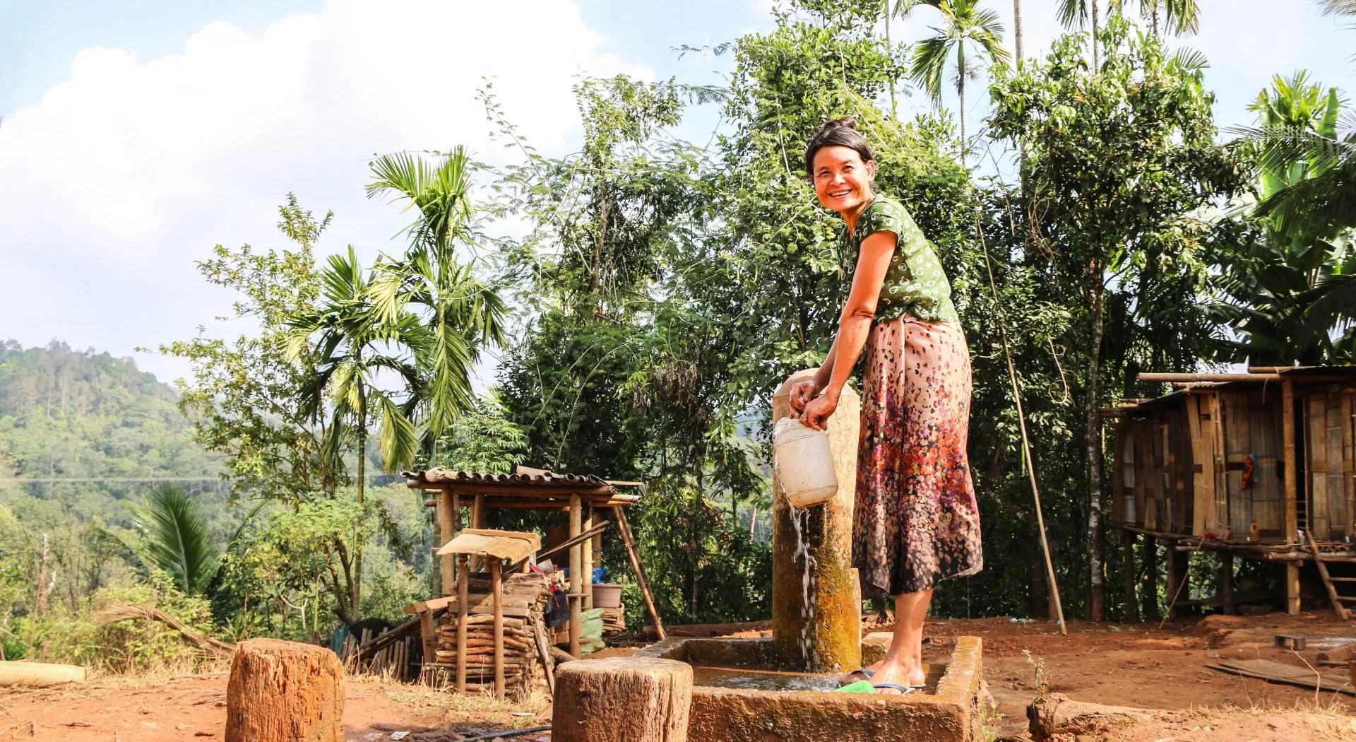 Myanmar: a woman getting water from a pump